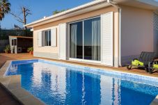 Piscina privada com espreguiçadeiras e vista para o Funchal